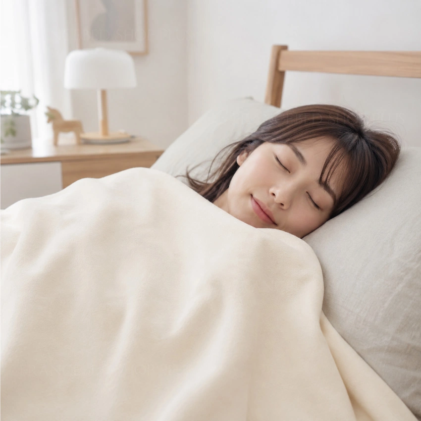 女性がオールオーガニックコットン毛布を使用して寝ている画像